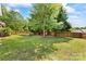 A spacious backyard with a fire pit and Adirondack chairs for outdoor enjoyment at 1728 Privette Rd, Matthews, NC 28105