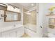 Bathroom features a bathtub with glass door and white vanity at 1728 Privette Rd, Matthews, NC 28105