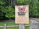 Image of The Butterfly Highway sign dedicated to native plants and food sources, with nearby walking trail at 1728 Privette Rd, Matthews, NC 28105
