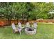 The backyard features a stone fire pit and four Adirondack chairs, perfect for cozy evenings at 1728 Privette Rd, Matthews, NC 28105
