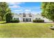 Charming white home with dormers, a covered porch, and a lush green lawn at 1728 Privette Rd, Matthews, NC 28105