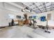 Spacious garage with overhead storage and work-out equipment at 1728 Privette Rd, Matthews, NC 28105