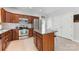 Kitchen with an island, stainless steel appliances, wood cabinets, and tile floors at 1728 Privette Rd, Matthews, NC 28105