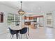 Open kitchen and dining area with tile floors, central island, and stainless steel appliances at 1728 Privette Rd, Matthews, NC 28105