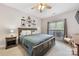 Relaxing main bedroom with wood accents, ceiling fan, neutral walls, and comfortable bedding at 1728 Privette Rd, Matthews, NC 28105