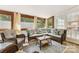Cozy sunroom featuring comfortable seating, brick floors, and ample natural light at 1728 Privette Rd, Matthews, NC 28105