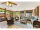 Comfortable sunroom with brick floors, ceiling fan, and ample seating at 1728 Privette Rd, Matthews, NC 28105