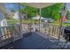 Covered back porch with stairs leading to a spacious yard, and outdoor seating areas at 174 Perrin Dr, Mooresville, NC 28117