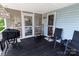 Cozy screened back porch with a grill, welcome sign, and seating at 174 Perrin Dr, Mooresville, NC 28117