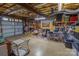 An unfinished basement with a garage door, overhead lighting, exposed ceiling, and a concrete floor at 174 Perrin Dr, Mooresville, NC 28117