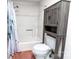 Modern white bathroom with shower/tub and gray wood storage cabinet at 174 Perrin Dr, Mooresville, NC 28117