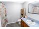 Neutral bathroom featuring a cabinet, sink, mirror, commode, and floral shower curtain at 174 Perrin Dr, Mooresville, NC 28117