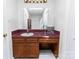 Neutral bathroom with a wood vanity, sink, mirror, and under cabinet knee-hole at 174 Perrin Dr, Mooresville, NC 28117