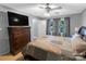 Comfortable bedroom featuring neutral walls, a ceiling fan, large dresser, and large window at 174 Perrin Dr, Mooresville, NC 28117