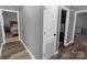 Hallway with neutral paint and trim, showing access to several rooms, with a hall closet visible at 174 Perrin Dr, Mooresville, NC 28117