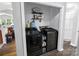 Convenient laundry room with sleek, modern washer and dryer, built in shelving, and ample storage space at 174 Perrin Dr, Mooresville, NC 28117
