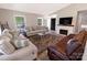 Relax in this living room with fireplace, with neutral tones and plush couches, with a view to the front door at 174 Perrin Dr, Mooresville, NC 28117