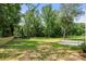 Expansive backyard featuring lush greenery and mature trees providing a private and serene outdoor space at 1820 Shannonhouse Dr, Charlotte, NC 28215