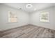 Neutral bedroom with hardwood floors, two windows with blinds and clean white walls at 1820 Shannonhouse Dr, Charlotte, NC 28215