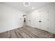 Bright bedroom with light wood-look floors, white walls, closet and modern ceiling light fixture at 1820 Shannonhouse Dr, Charlotte, NC 28215