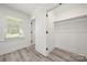 Bright bedroom with a window, vinyl floors, closet and white trim at 1820 Shannonhouse Dr, Charlotte, NC 28215