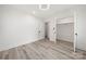 Bright bedroom with light wood-look floors, white walls and closet with opened door at 1820 Shannonhouse Dr, Charlotte, NC 28215