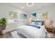 Staged bedroom with modern decor, light hardwood floors, rug, and a large bed at 1820 Shannonhouse Dr, Charlotte, NC 28215