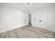 Bright bedroom with light wood-look floors, white walls, closet and modern ceiling light fixture at 1820 Shannonhouse Dr, Charlotte, NC 28215