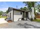 Exterior of the home featuring white brick and black trim and new roof at 1820 Shannonhouse Dr, Charlotte, NC 28215