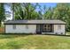 Charming one-story home showcasing a freshly painted white brick exterior, gray roof, and well-manicured front yard at 1820 Shannonhouse Dr, Charlotte, NC 28215