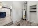 View of hallway leading to kitchen and bonus room, with water heater on display at 1820 Shannonhouse Dr, Charlotte, NC 28215