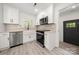 Well-lit kitchen features stainless steel appliances, white cabinets, and a farmhouse sink at 1820 Shannonhouse Dr, Charlotte, NC 28215