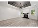 Spacious living room with fireplace, contemporary lighting, and large windows at 1820 Shannonhouse Dr, Charlotte, NC 28215