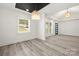 Open concept living room with white trim, wood-look floors, modern lighting, and great natural light at 1820 Shannonhouse Dr, Charlotte, NC 28215