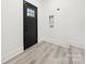 Mud room area with black door, washer and dryer hookups, with vinyl flooring at 1820 Shannonhouse Dr, Charlotte, NC 28215