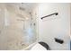 Shower featuring a glass door with marble backsplash and black fixtures at 1820 Shannonhouse Dr, Charlotte, NC 28215