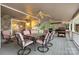 Spacious covered porch with a stone wall, multiple ceiling fans and a large gas grill at 192 Diana Dr, Mount Gilead, NC 27306