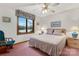 Comfortable bedroom with scenic lake views from the large window, complemented by a ceiling fan at 192 Diana Dr, Mount Gilead, NC 27306