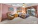 Comfortable bedroom featuring a recliner, bed, and access to a balcony with lake views at 192 Diana Dr, Mount Gilead, NC 27306