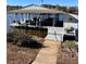 Dock by the waterside features seating arrangements and boat parking, perfect for Lake Wylie living at 192 Diana Dr, Mount Gilead, NC 27306