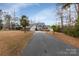 Attractive house with a long driveway, stone accents and palm trees at 192 Diana Dr, Mount Gilead, NC 27306