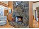 Living room with a stone fireplace, wood floors, and wood paneling at 192 Diana Dr, Mount Gilead, NC 27306