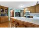 Kitchen showcases a breakfast bar with tiled countertop, oak cabinets, and modern appliances at 192 Diana Dr, Mount Gilead, NC 27306
