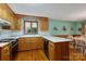 Charming kitchen featuring oak cabinets, a tile countertop, and a breakfast bar area with seating at 192 Diana Dr, Mount Gilead, NC 27306