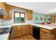 Bright kitchen with wooden cabinetry, tile countertops, and a breakfast bar at 192 Diana Dr, Mount Gilead, NC 27306