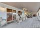 Relax on this spacious covered porch with wicker seating, ceiling fans, and sliding glass doors at 192 Diana Dr, Mount Gilead, NC 27306