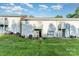 Exterior view of the back of townhomes with balconies and a grassy yard with mature trees at 2026 Harvest Ln, Charlotte, NC 28210