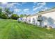 View of townhouse back exteriors, featuring balconies, and grassy backyard at 2026 Harvest Ln, Charlotte, NC 28210