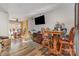 Open floor plan with a dining area featuring seating and a view of the living room with its TV at 2026 Harvest Ln, Charlotte, NC 28210