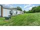 View of the back of the townhome with patios and a spacious green lawn at 2026 Harvest Ln, Charlotte, NC 28210